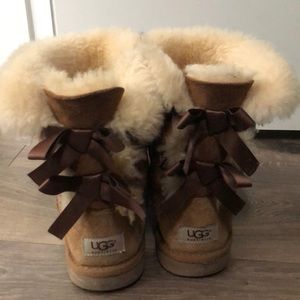 Light Brown Ugg boots with bows on the back